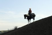 A woman rides down a hillside