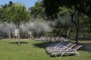 Water vapour sprays over loungers near the poolside