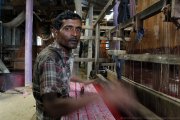 A weaver at his loom in the village of Tangail, Bangladesh